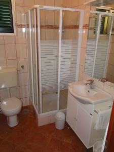 a bathroom with a shower and a sink and a toilet at Apartments in Primosten - Sibenik Riviera 45749 in Primošten