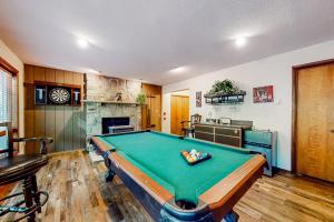 a kitchen with a pool table in a room at Whispering Woods in East Stroudsburg