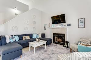 a living room with a blue couch and a fireplace at 3224 Birdseye Circle in Gulf Breeze