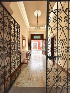 an open door to a hallway with a gate at Hotel Cantera Real, Morelia in Morelia