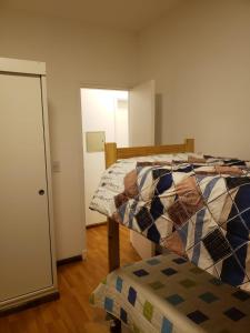 a bedroom with a bed and a doorway to a room at Matilde`s Sun in Godoy Cruz