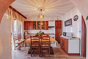 a kitchen with a table and chairs in a room at Apartments by the sea Prigradica, Korcula - 627 in Blato