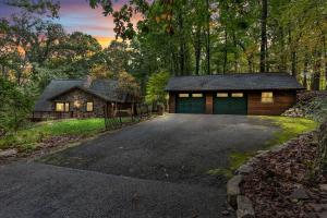 a house with a garage in the woods at Star Gazer Luxury A-Frame Wood Cabin. Near York/Harrisburg/Hershey/Lancaster in Goldsboro