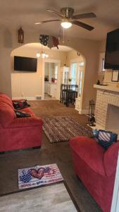 a living room with two red couches and a fireplace at *All-American Home Minutes From Case/UH/Cle Clinic in Cleveland Heights