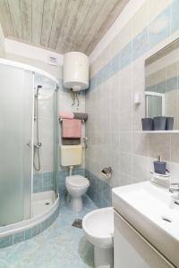 a bathroom with a toilet sink and a shower at Apartments by the sea Duga Luka - Prtlog, Labin - 2335 in Labin