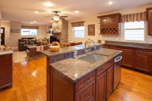 a kitchen with a sink and a living room at Stunning City Living Open Floor Plan in Pittsburgh