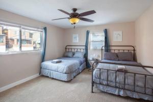 a bedroom with two beds and a ceiling fan at Stunning City Living Open Floor Plan in Pittsburgh