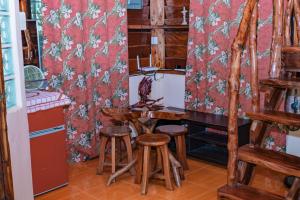a kitchen with a table and stools in a room at Ana's Bungalow in Siquijor