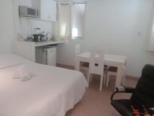 1 dormitorio con 1 cama, 1 mesa y 1 silla en Monterrico Suites Hotel, en Lima