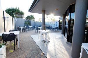 a restaurant with tables and chairs on a patio at The Stirling Motel in Rockhampton
