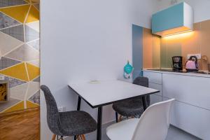 a kitchen with a white table and chairs at Apartments and rooms by the sea Banjol, Rab - 5077 in Rab