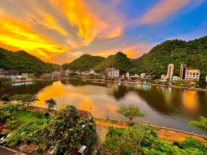 a view of a river in a city at sunset at Bao Phuc Hotel in Cat Ba