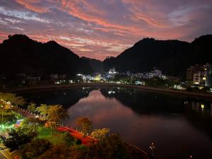 a view of a city with a lake at night at Bao Phuc Hotel in Cat Ba