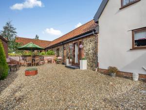 an external view of a house with a patio at Pear Tree Cottage in Banham