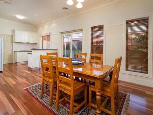 a kitchen and dining room with a wooden table and chairs at 'Ampleforth East' in Albury