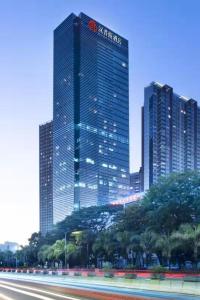 a large building in a city with tall buildings at Hamps Hotel ShenZhen in Shenzhen
