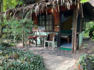 una pequeña casa con una mesa y una silla al aire libre en Dawn of Happiness, en Ao Nam Mao