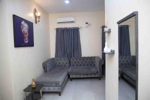 a living room with a couch and a table at Dabb Apartments in Ilorin