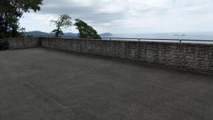 a stone retaining wall next to the ocean at Ochihime no Yado / Vacation STAY 7615 in Nagasaki