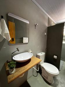 a bathroom with a sink and a toilet at Casa do Chafariz Tiradentes in Tiradentes