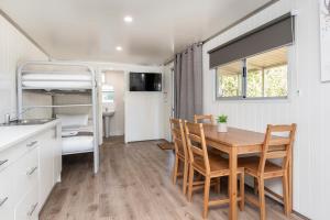 a kitchen and dining room with a table and chairs at Banksia Tourist Park in Perth