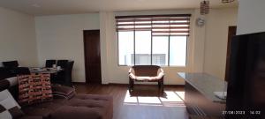 a living room with a couch and a table at Vive tu experiencia en la Altura in La Paz