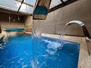 a water fountain in a swimming pool at Unique Mine Luxury SMART LOFTS in Bogotá