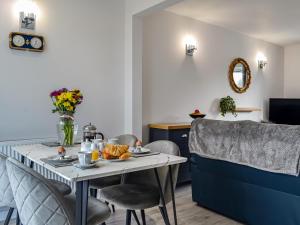 a dining room with a table with food on it at Anchor Cottage in Portpatrick