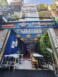 a restaurant with tables and chairs in front of a building at Beauty House in Ho Chi Minh City