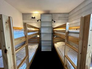 a group of three bunk beds in a room at Appartement La Plagne, 2 pièces, 6 personnes - FR-1-351-75 in La Plagne