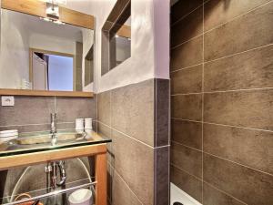 a bathroom with a sink and a mirror at Chalet Plagne 1800, 6 pièces, 12 personnes - FR-1-455-238 in La Plagne Tarentaise