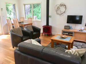 a living room with a couch and a fire place at Haven Villa in Berry