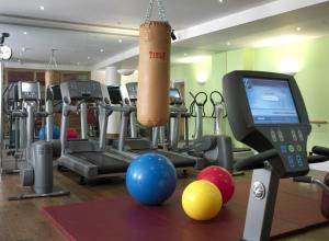 a gym with exercise equipment and a treadmill and a television at The Soho Hotel, Firmdale Hotels in London