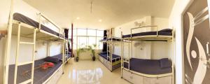 a room with three bunk beds in a building at Hotstel Udaipur in Udaipur