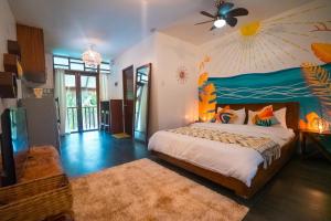 a bedroom with a bed and a ceiling fan at Villa Cali Siargao in General Luna