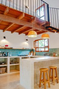 的住宿－Auen Posada Andina，厨房设有木制天花板和带凳子的台面。