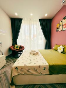 a bedroom with a large bed and a chair at Godidi Homestay&Apartment ( Westlake ) in Hanoi