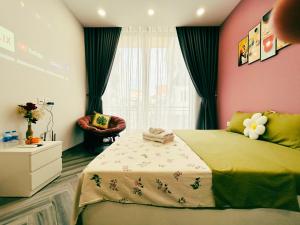a bedroom with a bed and a chair and a window at Godidi Homestay&Apartment ( Westlake ) in Hanoi
