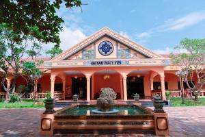 a building with a fountain in front of it at Spatel d'Annam - Imperial Boutique Spa & Hotel in Hue