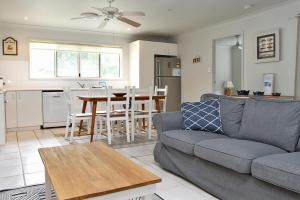 a living room with a couch and a table at KIAMA AMITY POINT in Amity Point