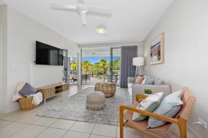 a living room with a couch and a tv at Drift Apartments - Tweed Coast Holidays ® in Kingscliff