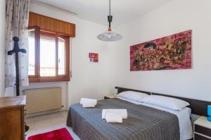 a bedroom with a bed with two white towels on it at Appartamenti Massimiliano in Peschiera del Garda