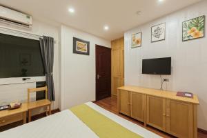 a bedroom with a bed and a flat screen tv at Hanoi Central Park Hotel in Hanoi