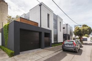a car parked in front of a building with a garage at Zen State of Mind - Calming Richmond Retreat in Melbourne