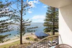 a balcony with a view of the beach and water at Eastbourne U6 80 Esplanade Golden Beach in Caloundra