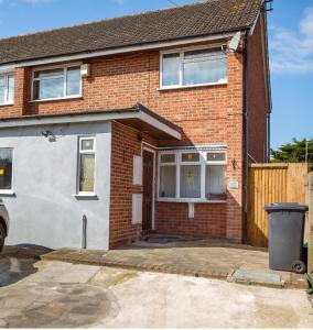 a brick house with a driveway in front of it at Beechtree House in Cheshunt