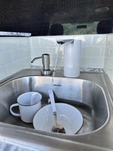 a sink with a bowl and a spoon in it at HW Campervan Rental NO CAMPGROUND in Hauula