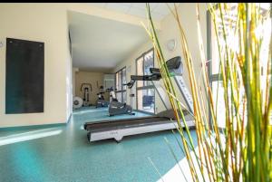um ginásio com passadeira numa sala com relva em Appartement Golf de Saumane 2 chambres 2 à 4 personnes em Saumane-de-Vaucluse