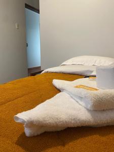 uma cama com duas toalhas brancas em cima em VILLA VICTORIA em Chachapoyas