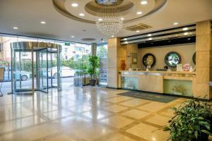 a lobby of a hotel with a reception desk at Shanghai Joyful Star Hotel-Free shuttle bus to Pudong Airport and Disney in Shanghai